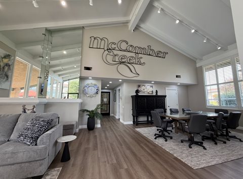 A McComber Creek sign is on the wall above a conference table.